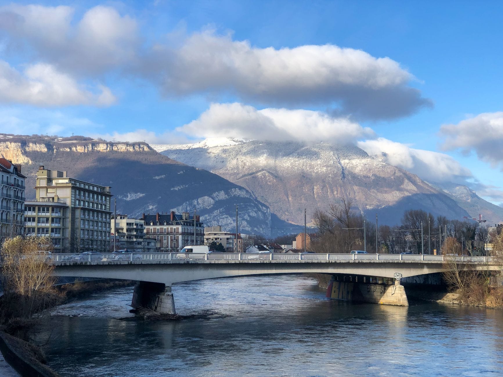 Grenoble, ses immeubles et les massifs alpins en arrière-plan